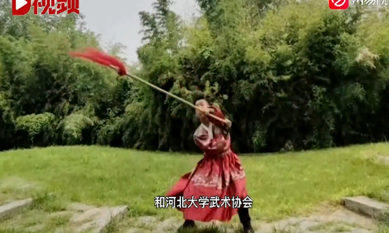 Dressed in traditional Chinese costume, the student surnamed Zhang, practiced martial arts with a gun and sword on the school playground, park, and lawn.Screenshot of D Video