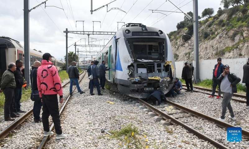 Staff check on a collided train in the south of Tunis, Tunisia, March 21, 2022. At least 72 people were injured when two trains collided on Monday morning in the south of Tunisia's capital Tunis, according to an official from Civil Defense Department.(Photo: Xinhua)