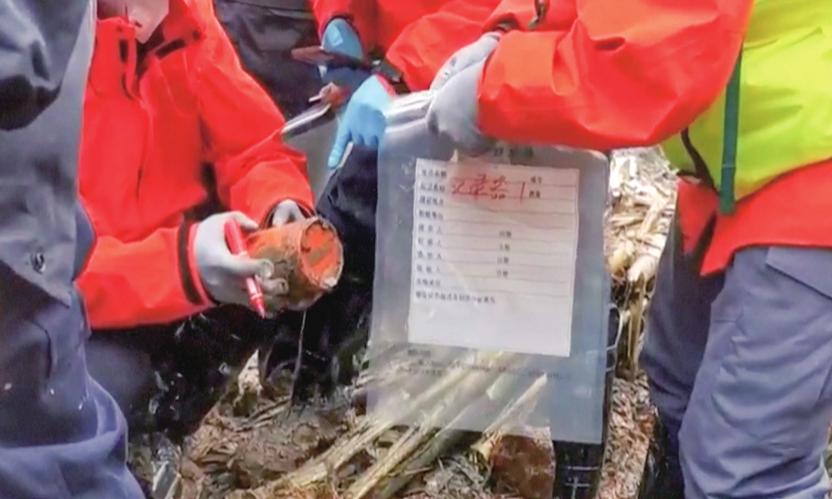 Rescuers recover one of the crashed plane's black boxes on March 23, 2022, which has been identified as the cockpit voice recorder. The flight data recorder is yet to be found. Photo: VCG