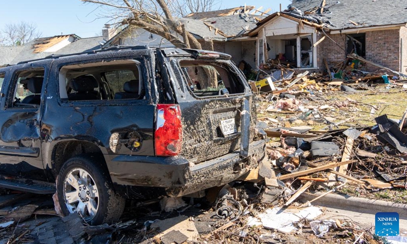 Photo taken on March 22, 2022 shows a damaged car in front of damaged houses after tornados in Round Rock, Texas, the United States. At least one person was killed and more than two dozens of others injured when tornados hit large areas of south central U.S. states Texas and Oklahoma on Monday evening, authorities said Tuesday.(Photo: Xinhua)