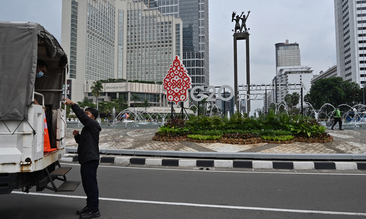 Workers are seen near ornamental signage promoting the upcoming 2022 G20 Summit in Jakarta, Indonesia on February 13, 2022.  Photo: AFP