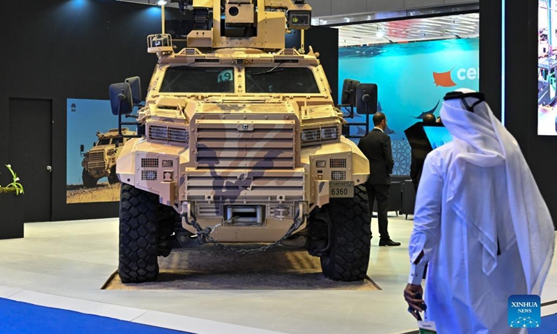 A visitor walks past an armored vehicle during his visit to the seventh edition of the Doha International Maritime Defence Exhibition & Conference (DIMDEX 2022) at the Qatar National Convention Centre in Doha, Qatar, March 21, 2022. Over 200 companies participated in the DIMDEX 2022.(Photo: Xinhua)