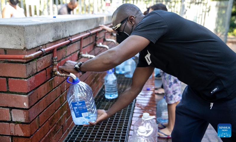 A person fills a bucket at Newlands Spring in Cape Town, South Africa, on March 19, 2022.(Photo: Xinhua)