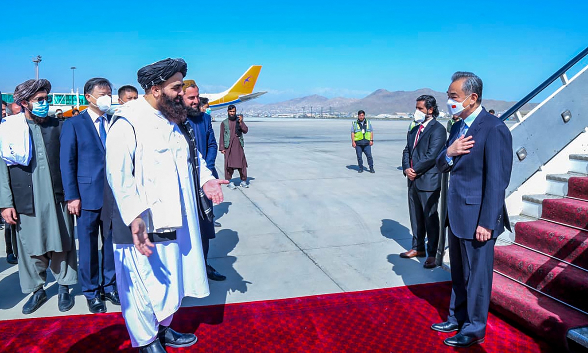 Acting foreign minister of Afghanistan Amir Khan Muttaqi (left) greets China's State Councilor and Foreign Minister Wang Yi (right) on his arrival at Kabul airport on March 24, 2022. Photo: AFP