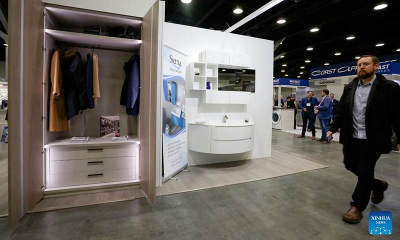 A man walks past kitchen and bath products during the 2022 BUILDEX show in Vancouver, British Columbia, Canada, on March 23, 2022. As one of Canada's largest conferences and trade shows for building industry, the 2022 BUILDEX Vancouver kicked off on Wednesday, showcasing the latest building materials, products and technologies.(Photo: Xinhua)