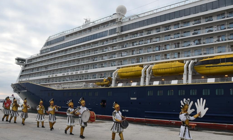 Staff members perform to welcome the arrival of tourists as cruise ship Spirit of Discovery docks at the port of La Goulette in Tunis, Tunisia, March 23, 2022.Spirit of Discovery is the first cruise ship to have docked in a Tunisian port since the outbreak of COVID-19 in early 2020.(Photo: Xinhua)