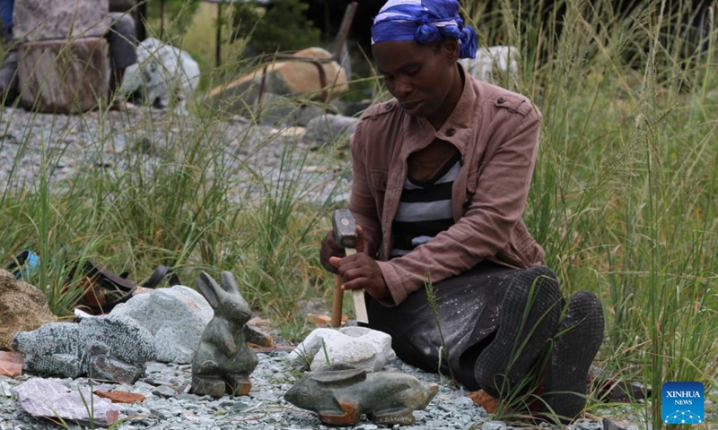 Simelokuhle Zibengwa, a stone sculptor at Chitungwiza Arts Center, works on a rock to make a sculpture in Chitungwiza, a town south of Harare, Zimbabwe, on March 17, 2022.(Photo: Xinhua)