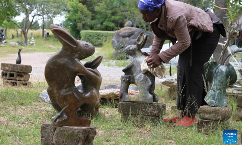 Simelokuhle Zibengwa, a stone sculptor at Chitungwiza Arts Center, polishes her sculpture in Chitungwiza, a town south of Harare, Zimbabwe, on March 17, 2022.(Photo: Xinhua)