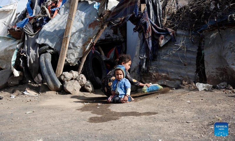 Children are seen in front of a ramshackle shelter at the Dharawan camp for internally displaced persons (IDPs) near Sanaa, Yemen, on March 25, 2022. Yemen has been mired in a civil war since late 2014 when the Iran-backed Houthi militia seized control of several northern provinces and forced the Saudi-backed Yemeni government of President Abd-Rabbu Mansour Hadi out of the capital Sanaa.(Photo: Xinhua)