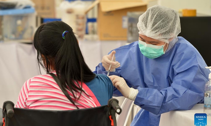 A woman receives a dose of the COVID-19 vaccine in Bangkok, Thailand, on April 4, 2022. (Xinhua/Rachen Sageamsak)