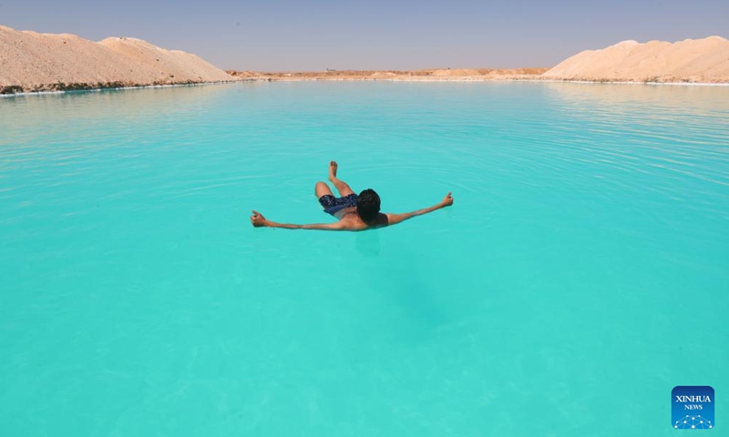 A man floats on a salt lake at Siwa Oasis in Matrouh Governorate, Egypt, on March 26, 2022.Photo:Xinhua