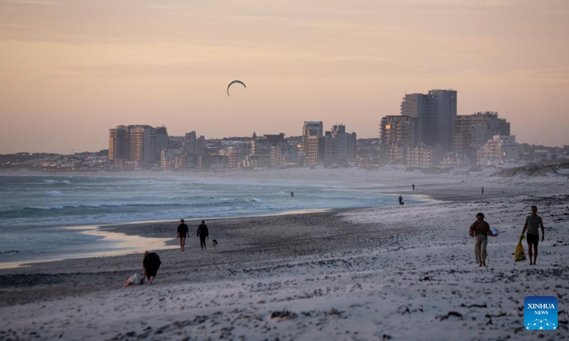 People walk on Sunset Beach at sunset in Cape Town, South Africa, on March 26, 2022.Photo:Xinhua