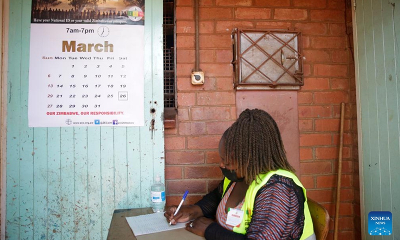 A staff member works at a polling station in Harare, Zimbabwe, on March 26, 2022.Photo:Xinhua