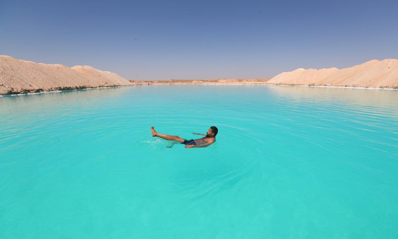A man floats on a salt lake at Siwa Oasis in Matrouh Governorate, Egypt, on March 26, 2022.Photo:Xinhua