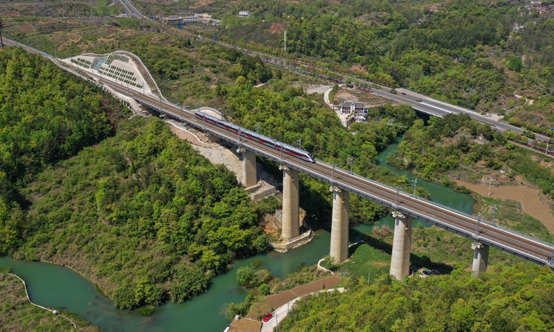 An aerial photo shows an intercity train in Guiyang, Southwest China's Guizhou Province, on April 7, 2022. From April 8, Chinese railways will implement a new map, with 3,300 kilometers of new lines. The number and frequency of freight trains and international trains will increase. China-Laos freight trains will operate every week. Photo: VCG