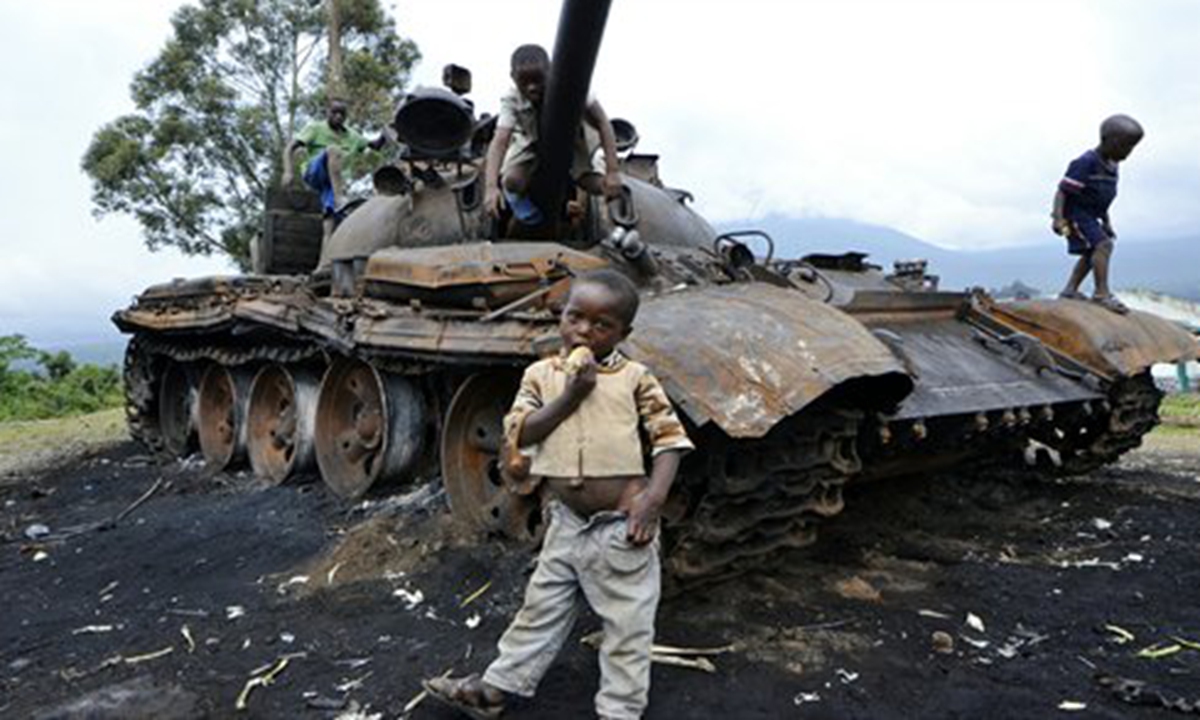 Children play on a burned tank which formerly belonged to M23 rebel soldiers, in Kimbumba, on Thursday. The day before, DR Congo troops captured the last stronghold of M23 rebels in the troubled east of the country, raising hopes of a return to the negotiating table. Photo: AFP