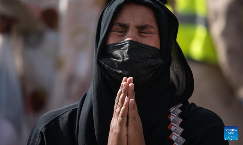 An Ethiopian migrant returning from Saudi Arabia prays after arriving at Addis Ababa Bole International Airport in Addis Ababa, Ethiopia, on March 30, 2022.(Photo: Xinhua)