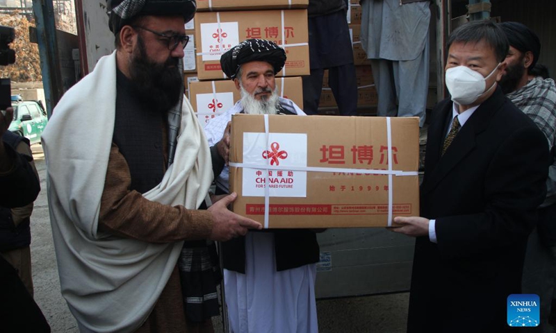 Chinese Ambassador to Afghanistan Wang Yu (R) and Afghan deputy minister of refugees and repatriation affairs of the caretaker government Arsala Kharoti (L) attend the handover ceremony of China-donated winter supplies in Kabul, capital of Afghanistan, Dec. 13, 2021. The second batch of winter supplies donated by China has arrived in Kabul. (Photo: Xinhua)