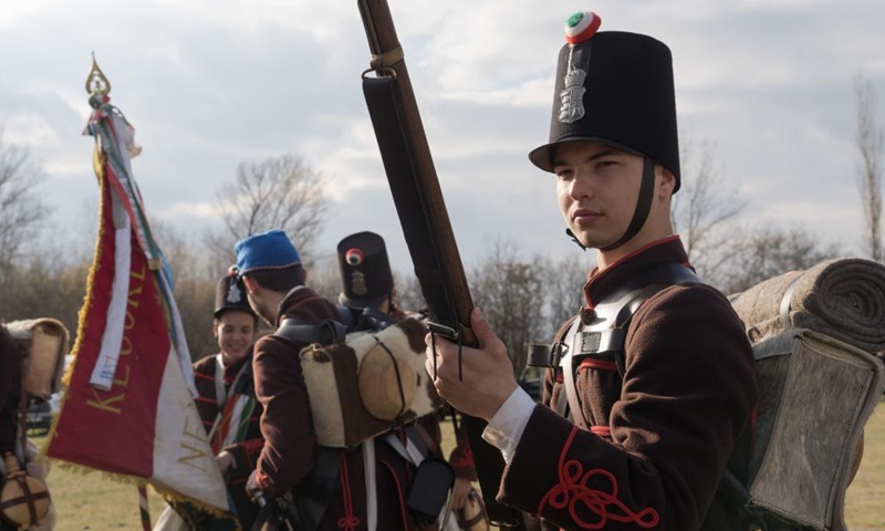 People in period military uniforms re-enact a historic battle in Tapiobicske, Hungary, April 4, 2022. Battle of Tapiobicske was fought on April 4, 1849 between the Hungarian army and the Austrian Empire during the Hungarian War of Independence. (Photo by Attila Volgyi/Xinhua)