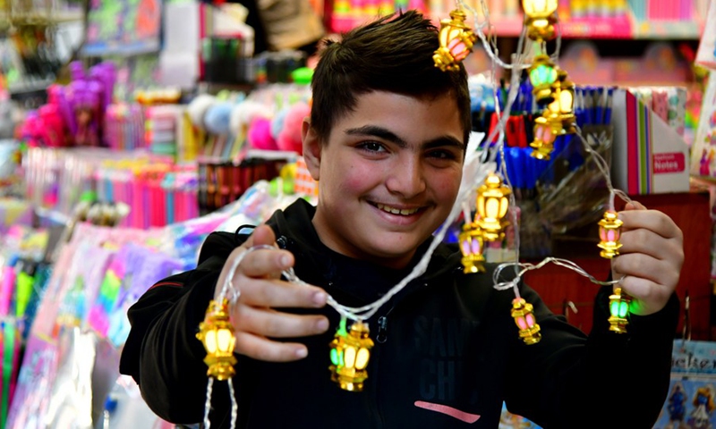 Syrians are seen shopping decorations for the upcoming holy month of Ramadan in the capital Damascus on March 27, 2022.(Photo: Xinhua)
