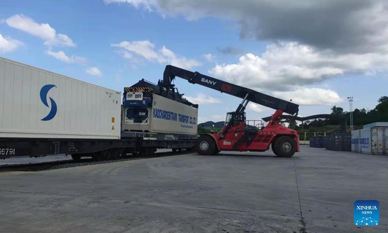The containers of fruits from Thailand are transported from China-Laos Railway cargo train to trucks at Nateuy Station in Luang Namtha Province, Laos, April 1, 2022.Photo:Xinhua