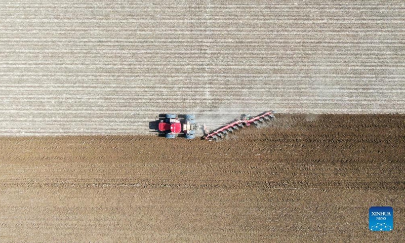 Aerial photo shows a tractor ploughing a cotton field in Shawan City, northwest China's Xinjiang Uygur Autonomous Region, April 2, 2022. Spring farming has started in northern Xinjiang. In 2022, local authorities will strive to achieve a mechanization level of 85.7 percent for all crops in Xinjiang. Photo: Xinhua