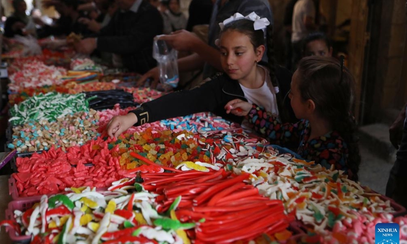 People visit a market during the Islamic holy month of Ramadan in the West Bank city of Hebron, on April 5, 2022. (Photo by Mamoun Wazwaz/Xinhua)