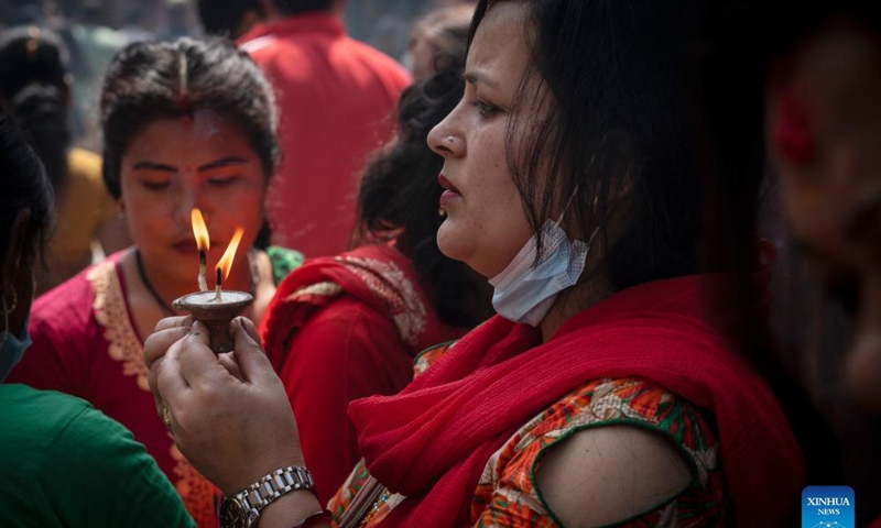 Devotees offer butter lamps to mark the birth of Lord Ganesha in Kathmandu, Nepal, April 5, 2022. The elephant-headed Lord Ganesha is worshiped as the god of new beginnings and the remover of obstacles. (Photo by Hari Maharjan/Xinhua)
