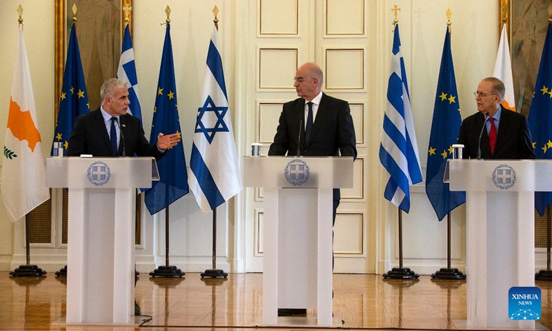 Israeli Foreign Minister Yair Lapid (L), Greek Foreign Minister Nikos Dendias (C) and Cypriot Foreign Minister Ioannis Kasoulides attend a press conference after a trilateral meeting of foreign ministers in Athens, Greece, on April 5, 2022. (Xinhua/Marios Lolos)