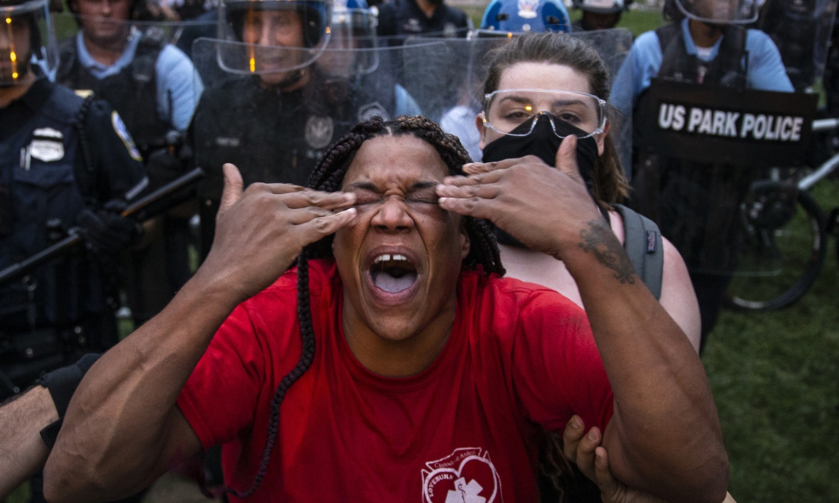 An African-American woman is pepper sprayed by the police during a 