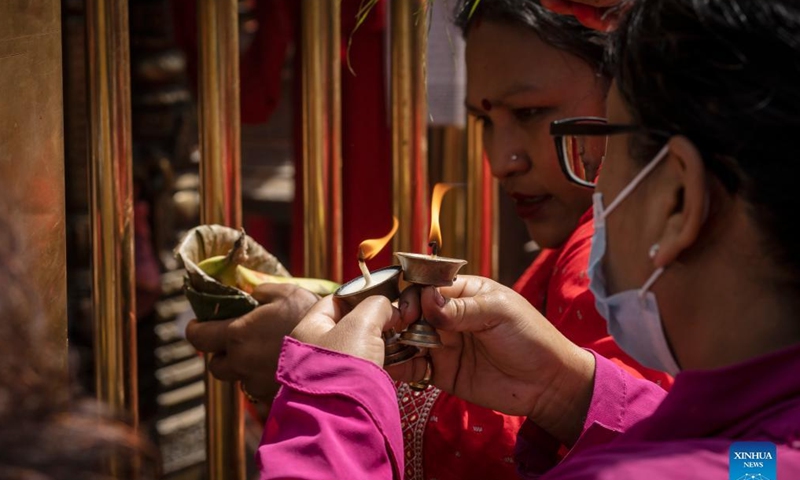 Devotees offer butter lamps to mark the birth of Lord Ganesha in Kathmandu, Nepal, April 5, 2022. The elephant-headed Lord Ganesha is worshiped as the god of new beginnings and the remover of obstacles. (Photo by Hari Maharjan/Xinhua)