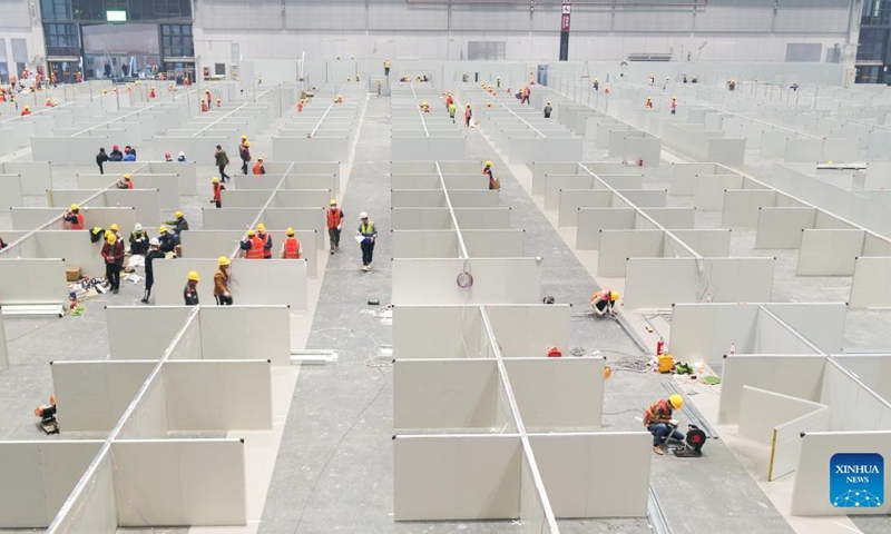 People work at the National Exhibition and Convention Center in east China's Shanghai, April 6, 2022. Shanghai is converting the National Exhibition and Convention Center (NECC) into a makeshift hospital with a planned capacity of 40,000 beds. Upon completion, it is expected to act as the biggest such hospital for those testing positive for COVID-19 in the metropolis.(Photo: Xinhua)