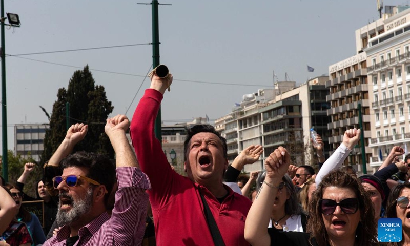Demonstrators shout slogans in downtown Athens, Greece, on April 6, 2022. Tens of thousands of Greeks walked off the job across the country on Wednesday to join a 24-hour general strike over soaring heating, electricity and housing costs. Public services and transport were disrupted. (Photo: Xinhua)