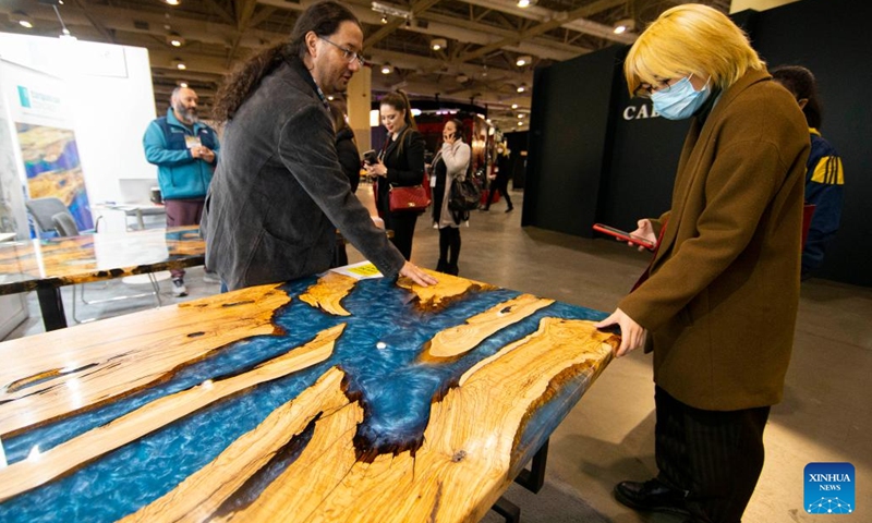Visitors look at a conference table during the 2022 Interior Design Show in Toronto, Canada, on April 7, 2022. As Canada's premier showcase of new interior design concepts and products, the annual event is held here from Thursday to Sunday.(Photo: Xinhua)