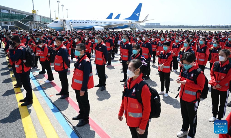 Medics gather before boarding for east China's Shanghai at Changle Airport in Fuzhou, southeast China's Fujian Province, April 7, 2022. A total of 1,730 supportive medics from Fujian Province set off on Thursday from Fuzhou and Xiamen to Shanghai to aid in the battle against the resurging COVID-19 epidemic.Photo:Xinhua
