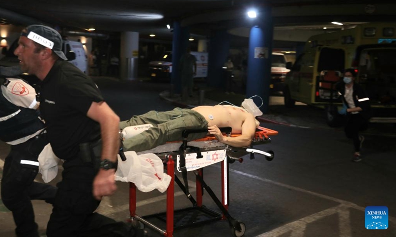 An injured man is transferred to a hospital following a shooting attack in Tel Aviv, Israel, on April 7, 2022. At least two people were killed and eight others injured in a shooting attack in Israel's coastal city of Tel Aviv on Thursday night, Israeli authorities said.(Photo: Xinhua)