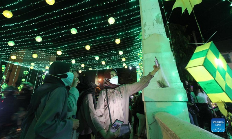People view illuminated installations during the holy month of Ramadan in Surakarta, Central Java, Indonesia, April 9, 2022.Photo:Xinhua