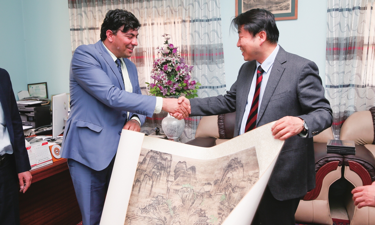 Below: Chinese and Afghan scholars exchange gifts as a Chinese expert delegation visited the National Museum of Afghanistan on March 25, 2018. Photo: Courtesy of Sun Zhijun/Dunhuang Academy