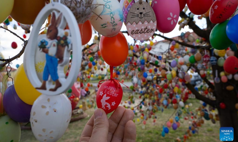 A tree decorated with Easter eggs is seen in the main square of Kethely, Western Hungary, on April 11, 2022.(Photo: Xinhua)
