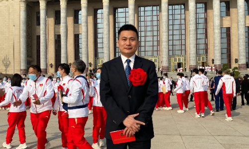 Zhang Xin, manager at the Air China Group, stands in front of the Great Hall of the People in Beijing on April 8, 2022. He is the recipient of the honorary title of 