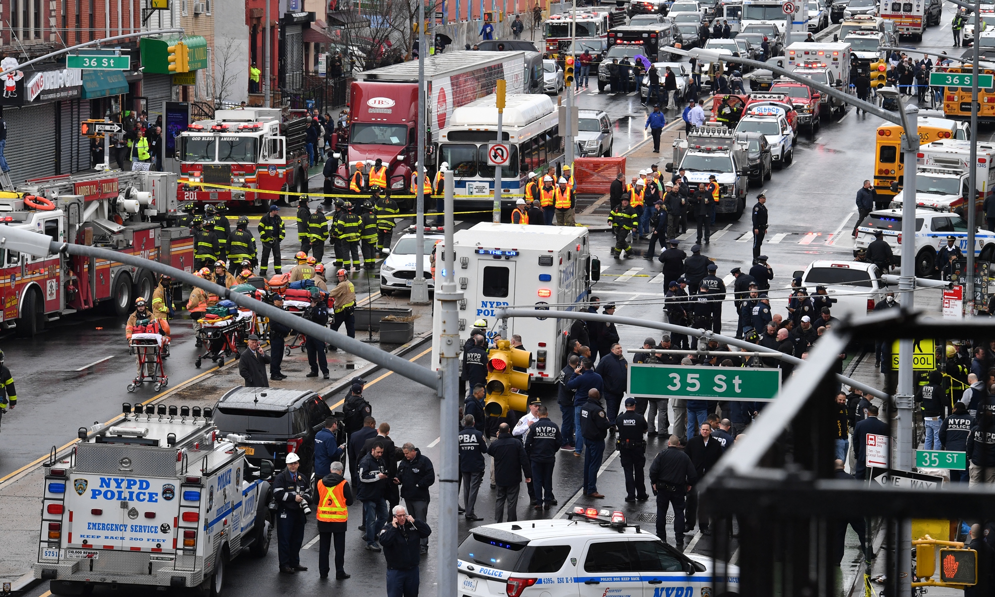 Members of the New York Police Department and emergency vehicles crowd the streets after at least 13 people were injured during a rush-hour shooting at a subway station in the New York borough of Brooklyn on April 12, 2022, where authorities said 