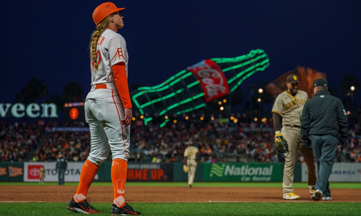Apr 12, 2022; San Francisco, California, USA; San Francisco Giants assistant coach Alyssa Nakken (92), the first female to coach on the field at first base, during the third inning against the San Diego Padres at Oracle Park. Photo: IC