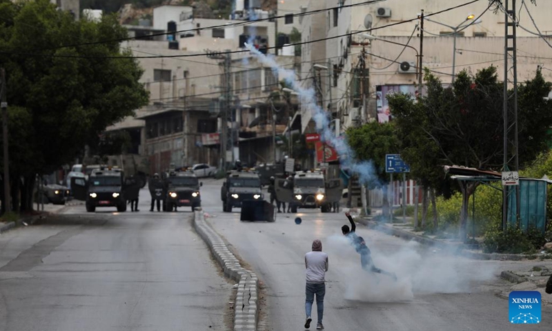 Israeli army forces and Palestinian protesters clash near the West Bank city of Nablus, April 13, 2022. Israeli soldiers killed a Palestinian and injured 31 others on Wednesday morning during clashes near the northern West Bank city of Nablus, said medics and eyewitnesses.(Photo: Xinhua)