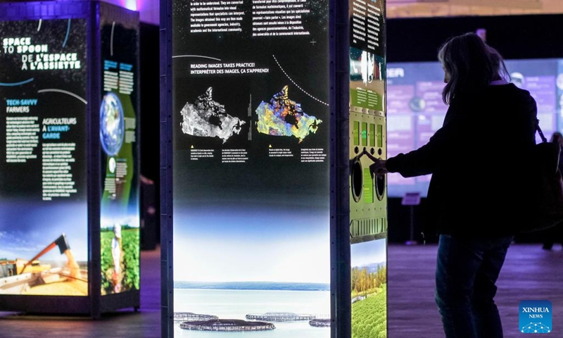 A woman visits the Stargazer exhibition in Delta, British Columbia, Canada, on April 13, 2022. The exhibition allows audience to explore the outer space experience through interactive displays, scale replicas of historic rockets, space stations, and satellites.(Photo: Xinhua)