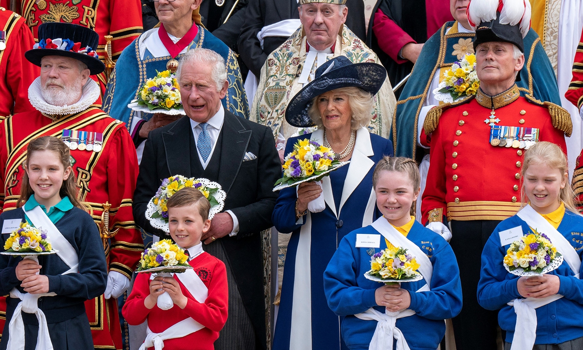 Britain's Prince Charles, Prince of Wales and Britain's Camilla, Duchess of Cornwall pose for a photo with Yeomen Warders, after taking part in the Royal Maundy Service at St George's Chapel in Windsor, London, on April 14, 2022. Photo: AFP