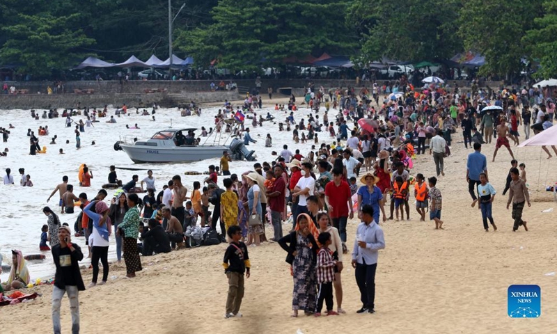 People enjoy the traditional New Year holiday at a seaside resort in Kep province, southwestern Cambodia on April 15, 2022. Cambodia on Thursday began to celebrate the three-day traditional New Year festival after muted celebrations in the last two years due to the COVID-19 pandemic. (Photo by Sovannara/Xinhua)