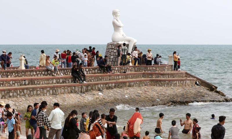 People enjoy the traditional New Year holiday at a seaside resort in Kep province, southwestern Cambodia on April 15, 2022. Cambodia on Thursday began to celebrate the three-day traditional New Year festival after muted celebrations in the last two years due to the COVID-19 pandemic. (Photo by Sovannara/Xinhua)