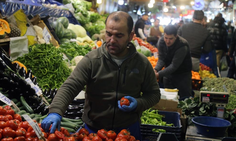 A vendor works at a market in Ankara, Turkey, on April 16, 2022.Photo:Xinhua