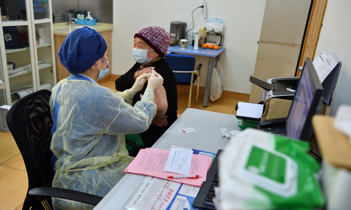 An elderly woman receives COVID-19 vaccine booster in Shanghai. Photo: VCG