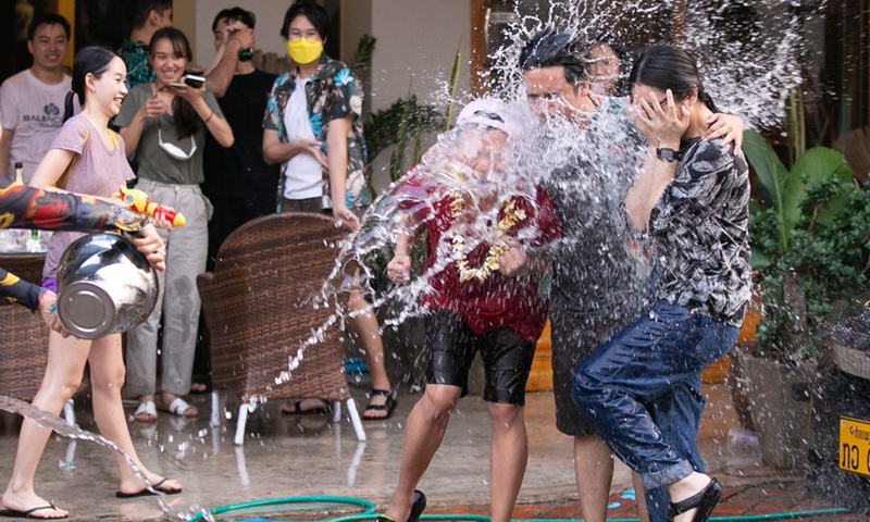 People splash water to each other to celebrate the Songkran Festival, or the Lao New Year, in Luang Prabang, Laos, April 14, 2022.(Photo: Xinhua)